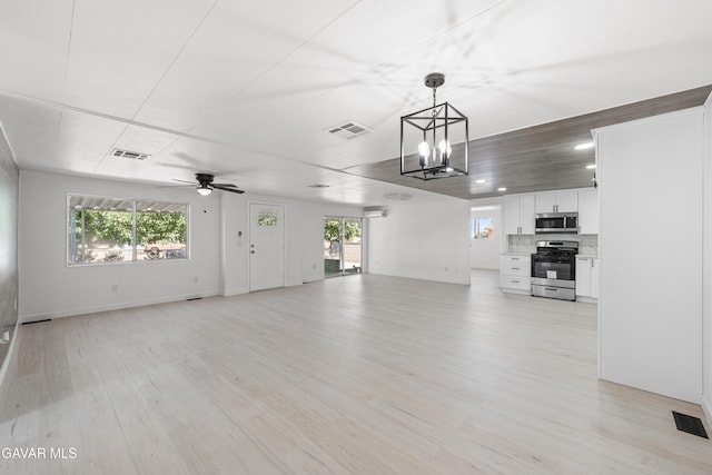 2465 W 55th St, Rosamond, CA 93560 - unfurnished living room featuring ceiling fan, a chandelier, light wood-type flooring, healthy amount of natural light, and recessed lighting