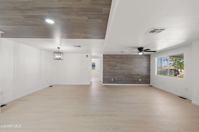 2465 W 55th St, Rosamond, CA 93560 - unfurnished living room with light wood-type flooring, ceiling fan, and wooden walls