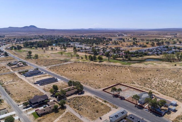 bird's eye view featuring a mountain view, a desert view, and a rural view