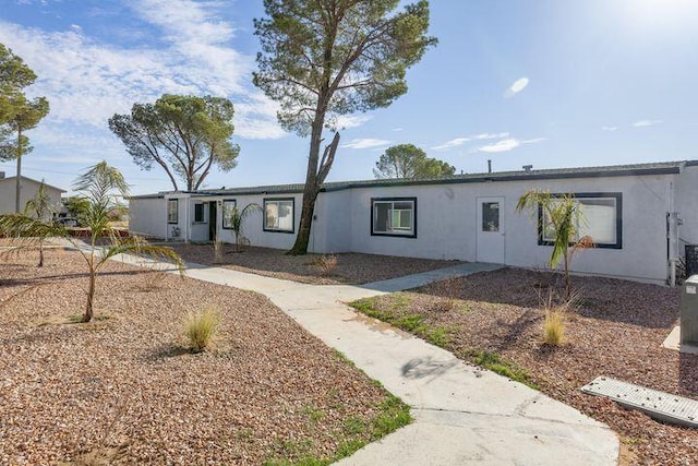 ranch-style house featuring stucco siding