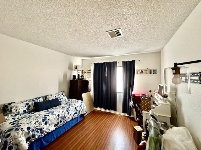 44200 Kingtree Ave Unit 6, Lancaster, CA 93534 - bedroom with a textured ceiling and wood finished floors