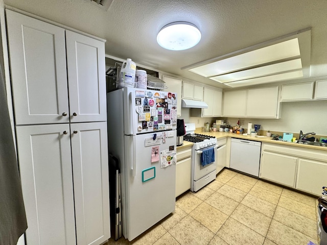 44200 Kingtree Ave Unit 6, Lancaster, CA 93534 - kitchen with white appliances, under cabinet range hood, light countertops, a textured ceiling, and light tile patterned floors