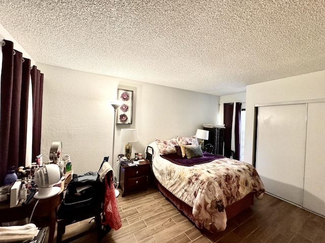 44200 Kingtree Ave Unit 6, Lancaster, CA 93534 - bedroom with a textured ceiling, a closet, light wood finished floors, and a textured wall