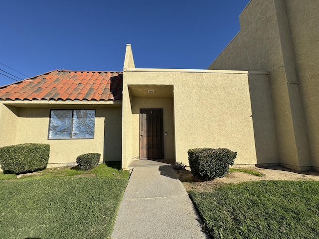 44200 Kingtree Ave Unit 6, Lancaster, CA 93534 - view of exterior entry featuring stucco siding and a tile roof