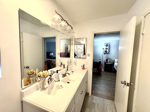 44200 Kingtree Ave Unit 6, Lancaster, CA 93534 - ensuite bathroom with vanity and wood finished floors