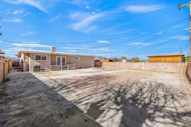 back of property featuring french doors and a patio