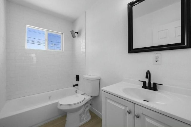 full bathroom with toilet, tiled shower / bath combo, vanity, and hardwood / wood-style floors