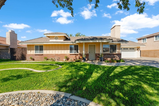 view of front of house featuring a garage and a front lawn