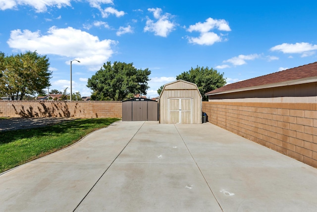 view of patio featuring a storage shed