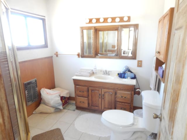 bathroom featuring tile patterned flooring, vanity, and toilet