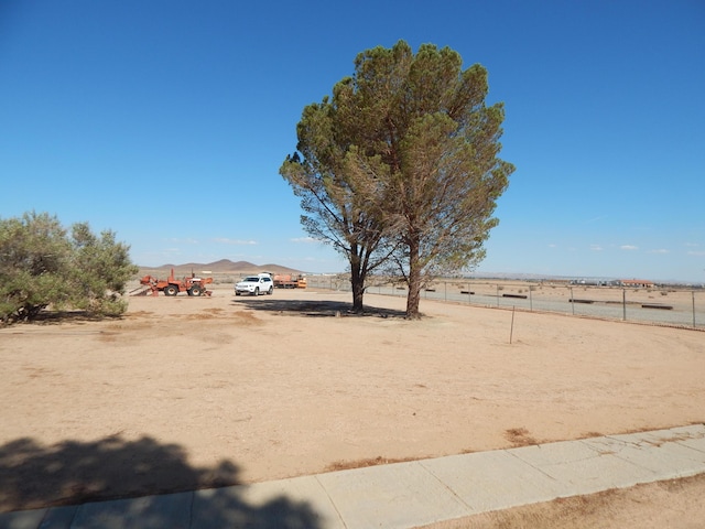 view of yard featuring a mountain view and a rural view