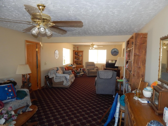 living room with carpet, a textured ceiling, and ceiling fan