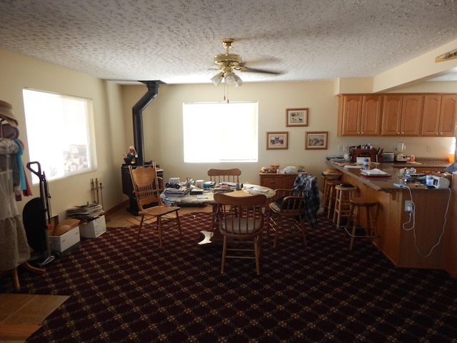 dining room featuring ceiling fan and a textured ceiling