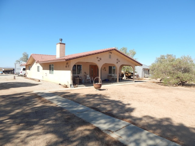 back of house with a patio