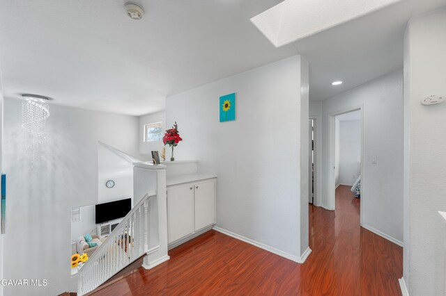 44559 Aspen St, Lancaster, CA 93535 - corridor featuring an upstairs landing, a skylight, wood finished floors, and recessed lighting