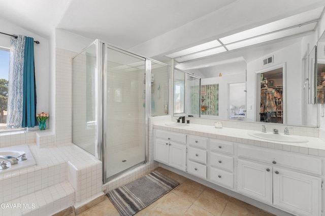 44559 Aspen St, Lancaster, CA 93535 - bathroom with double vanity, a stall shower, tile patterned flooring, a walk in closet, and tiled bath