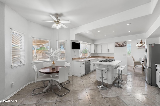 44559 Aspen St, Lancaster, CA 93535 - kitchen with stainless steel appliances, light countertops, healthy amount of natural light, white cabinets, and recessed lighting
