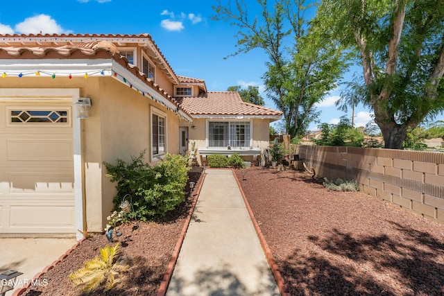 44559 Aspen St, Lancaster, CA 93535 - doorway to property featuring stucco siding, a tiled roof, and an attached garage