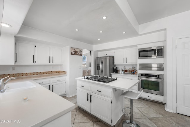 44559 Aspen St, Lancaster, CA 93535 - kitchen featuring appliances with stainless steel finishes, light countertops, recessed lighting, white cabinets, and a kitchen island