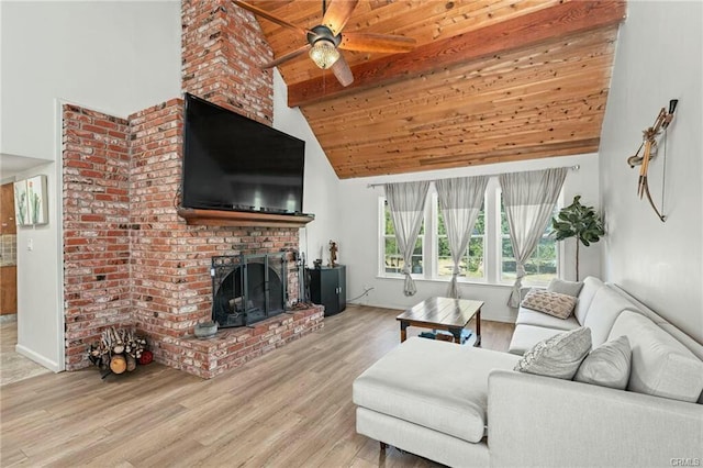 living area featuring light wood finished floors, wooden ceiling, beamed ceiling, a fireplace, and high vaulted ceiling