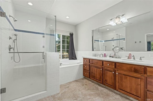 bathroom featuring double vanity, a garden tub, a sink, and a stall shower