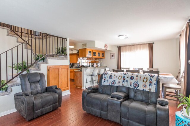 living area with dark wood-style floors and stairway