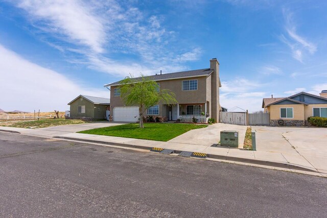 view of front of home with concrete driveway, stucco siding, fence, a front lawn, and a chimney