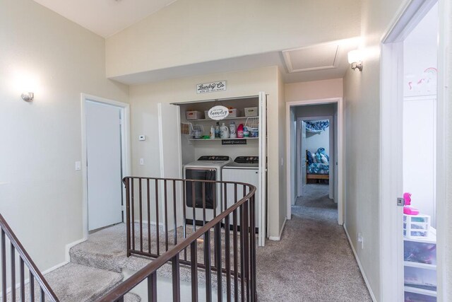 hall featuring baseboards, an upstairs landing, washer and dryer, and light colored carpet