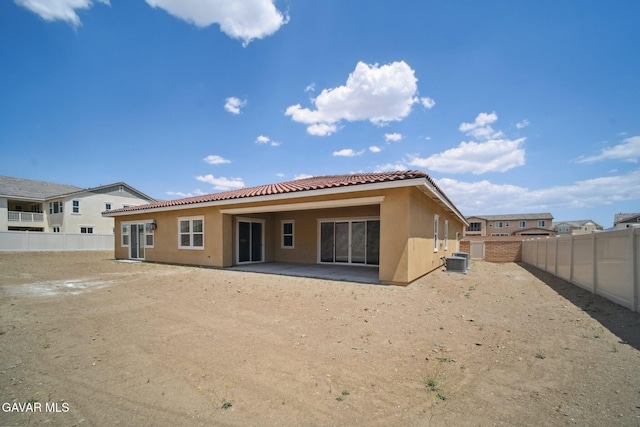 3716 Eliopulos Ranch Dr, Palmdale, CA 93551 - back of property featuring a tiled roof, stucco siding, a patio, and a fenced backyard