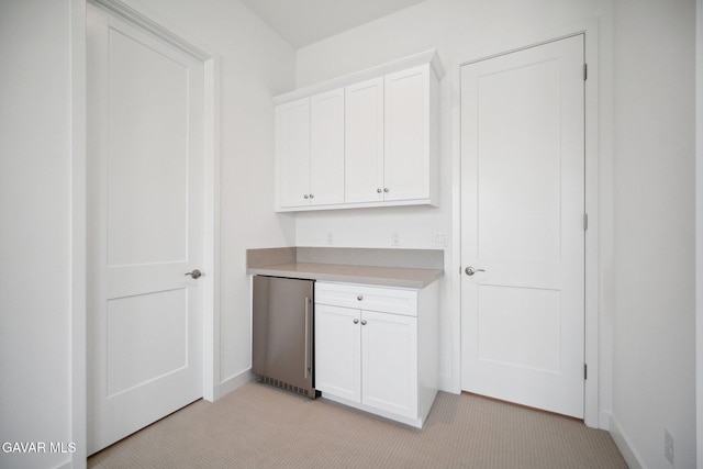 3716 Eliopulos Ranch Dr, Palmdale, CA 93551 - kitchen featuring stainless steel fridge, light carpet, white cabinets, and light countertops