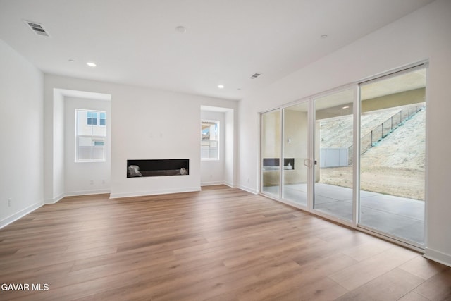 3716 Eliopulos Ranch Dr, Palmdale, CA 93551 - unfurnished living room featuring wood finished floors, recessed lighting, and a fireplace