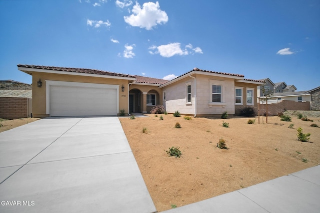 3716 Eliopulos Ranch Dr, Palmdale, CA 93551 - mediterranean / spanish-style house featuring a garage, stucco siding, concrete driveway, and a tiled roof