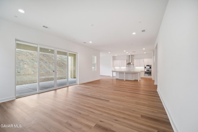 3716 Eliopulos Ranch Dr, Palmdale, CA 93551 - unfurnished living room with light wood finished floors and recessed lighting