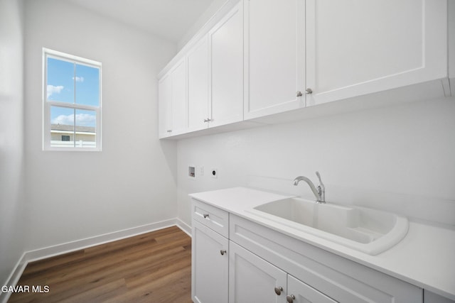 3716 Eliopulos Ranch Dr, Palmdale, CA 93551 - washroom with hookup for a washing machine, electric dryer hookup, cabinet space, and dark wood-style flooring