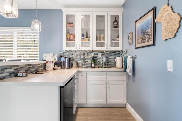 36755 Tierra Subida Ave, Palmdale, CA 93551 - bar with a sink, tasteful backsplash, light wood finished floors, and hanging light fixtures