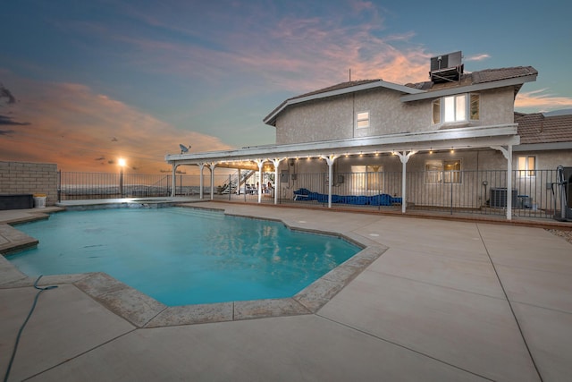 36755 Tierra Subida Ave, Palmdale, CA 93551 - pool at dusk featuring cooling unit, a patio, and a pool with connected hot tub