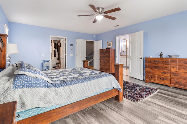 36755 Tierra Subida Ave, Palmdale, CA 93551 - bedroom featuring wood finished floors, a closet, ceiling fan, and a walk in closet