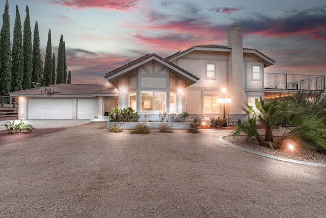 36755 Tierra Subida Ave, Palmdale, CA 93551 - view of front of home with stucco siding, a chimney, an attached garage, driveway, and a tiled roof
