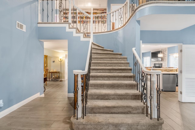 36755 Tierra Subida Ave, Palmdale, CA 93551 - staircase featuring a high ceiling, wood finished floors, and baseboards