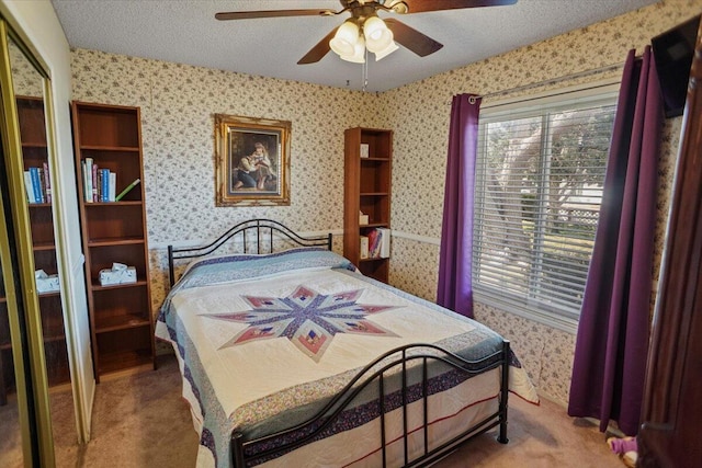 bedroom featuring a textured ceiling, carpet, and wallpapered walls