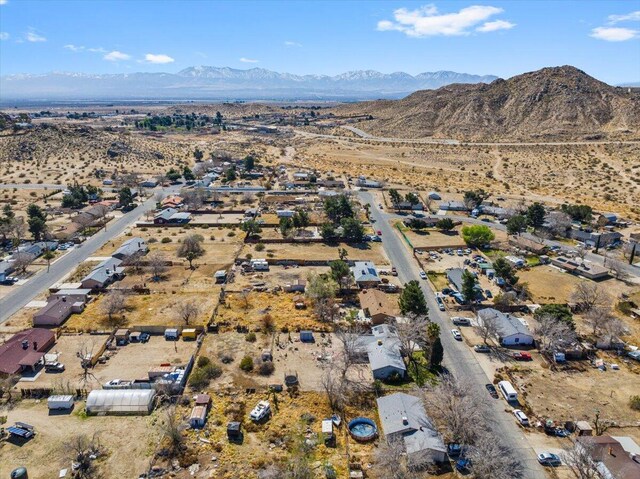 birds eye view of property with a mountain view and a desert view