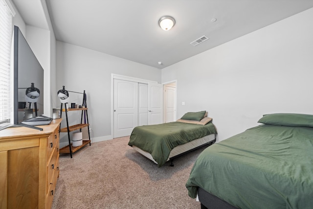 bedroom featuring a closet and carpet flooring