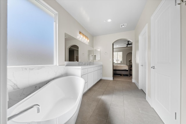 bathroom featuring vanity, a washtub, tile patterned flooring, and ceiling fan