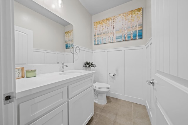 bathroom featuring vanity, tile patterned floors, and toilet