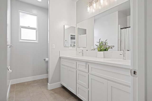 bathroom featuring tile patterned flooring and vanity