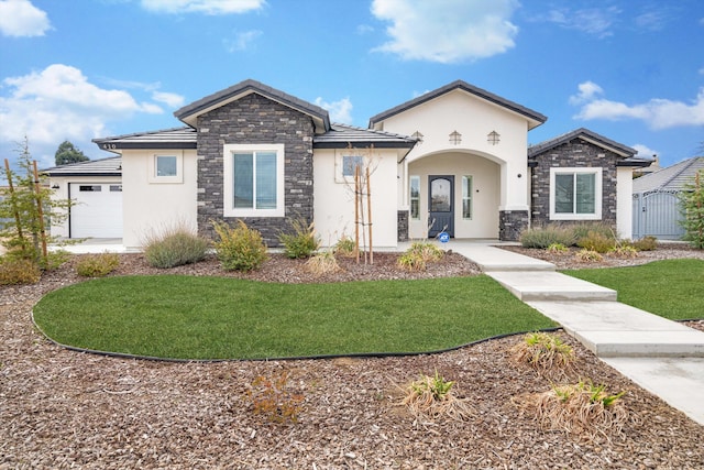 view of front of home with a garage and a front lawn