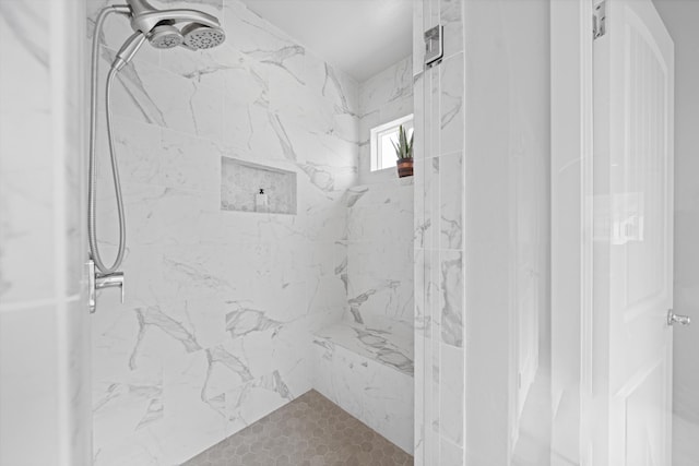 bathroom with tiled shower