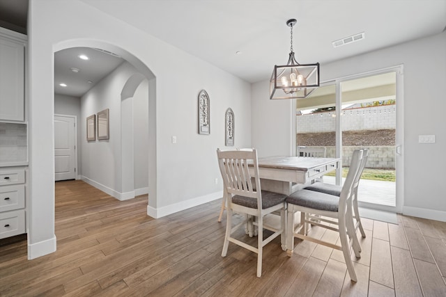 dining room with an inviting chandelier and light hardwood / wood-style floors