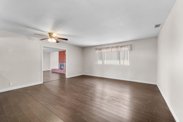 spare room featuring ceiling fan and dark wood-type flooring