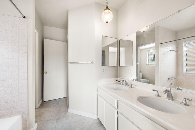 full bathroom featuring vanity, tiled shower / bath, tile patterned floors, and toilet